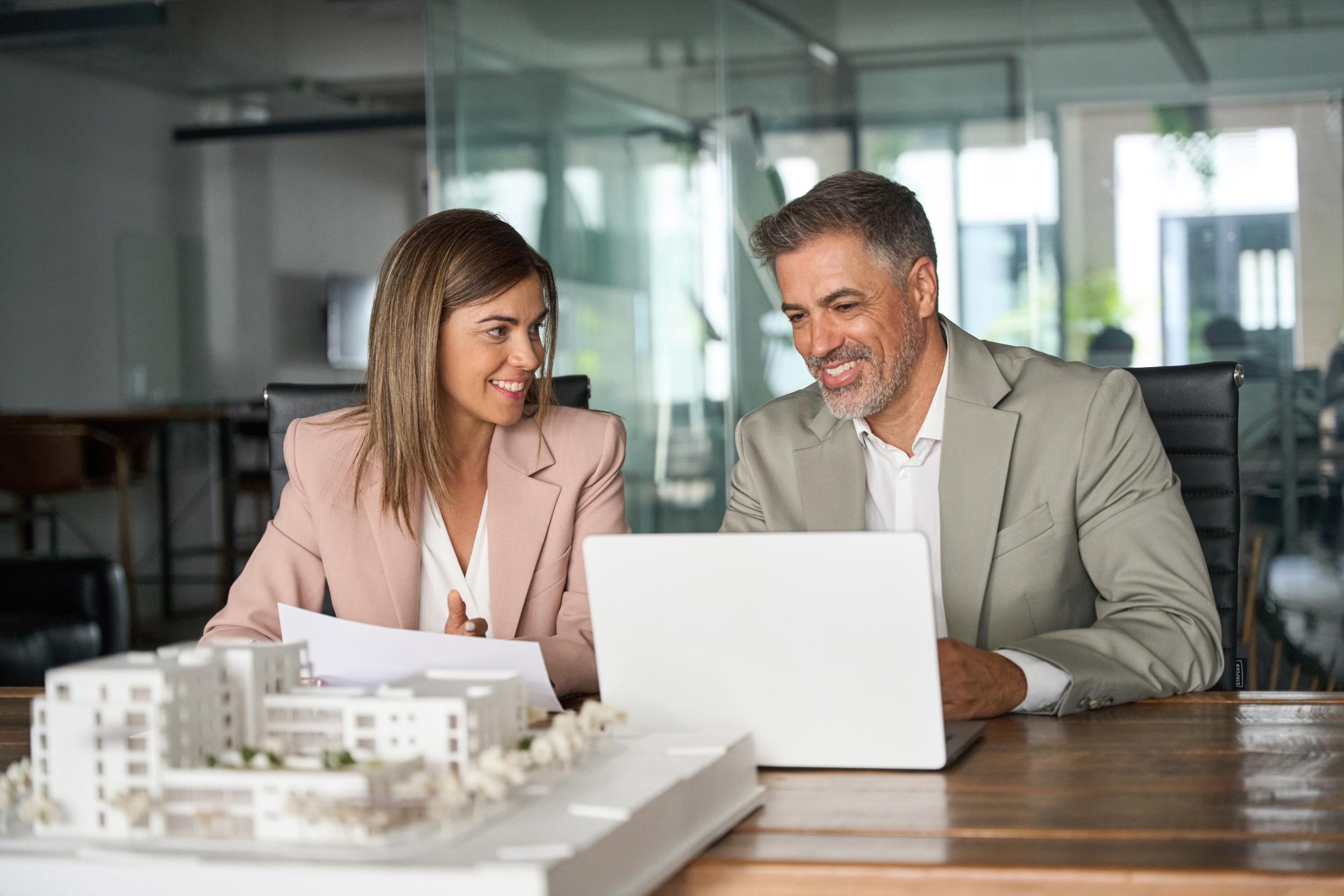 Real,estate,developers,working,on,laptop,discussing,new,residential,or